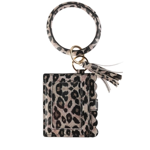 Detail of leopard print wristlet card holder featuring round keychain ring and tassel
