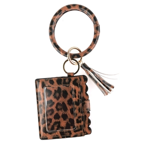 Close-up of leopard print PU leather card holder with tassel and gold metal ring handle