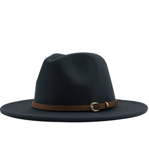Detail of wool fedora hat featuring brown leather band and gold metal buckle accent