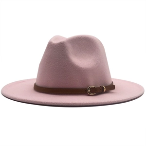 Detailed macro view of pink fedora wool hat with brown leather band and gold buckle