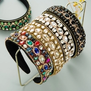 Detailed view of colorful baroque headbands with rhinestones on a metal display rack
