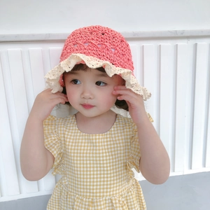 Pink hand-crocheted kids straw hat with lace brim and adjustable wind strap for sun protection