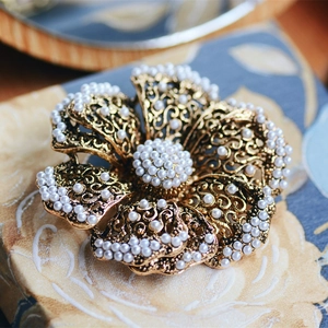 Vintage gold floral brooch with white pearls and delicate hollow filigree craftsmanship