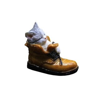 Sleeping gray cat figurine inside a brown resin boot ornament for home desk decor