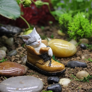 Cute resin cat sleeping in a miniature shoe figurine for garden and desk decor