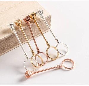 Macro detail of metal rose bud smoking rings in gold, silver and rose gold finishes