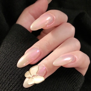 Long almond aurora pink press-on nails with 3D butterfly charms and pearl finish