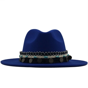 Detail of royal blue fedora hat with ethnic beaded band and vintage metal charms