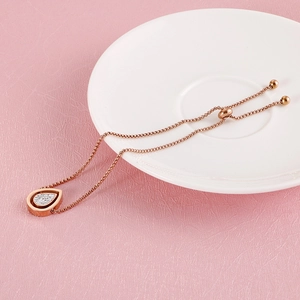 Rose gold adjustable stainless steel bracelet with a sparkling teardrop pendant