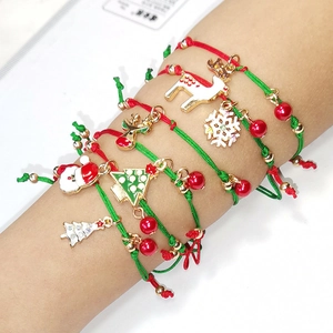 Braided Christmas bracelet set with Santa Claus and reindeer charms on model's wrist