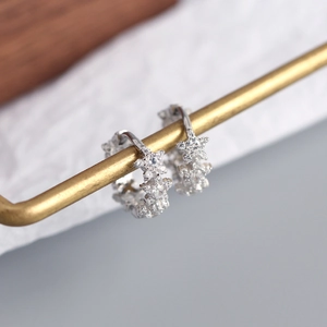 Macro shot of silver S925 sterling silver star earrings with sparkling cubic zirconia