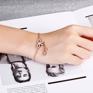 Rose gold butterfly bracelet with zircon inlay and snowflake charm worn on wrist