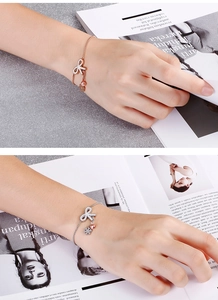Detailed view of elegant butterfly pull bracelets in rose gold and silver finish with zircons