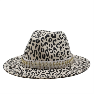Detail of leopard print fedora hat featuring white rhinestone studded band and wide brim