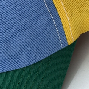 Multicolor propeller baseball cap featuring blue yellow green panels and contrast stitching
