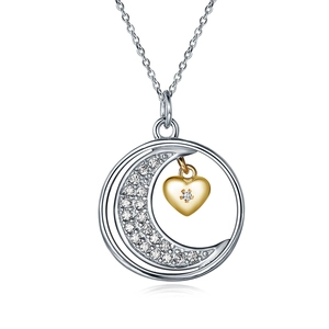 Detail of s925 silver moon pendant with gold heart and micro-paved zircons