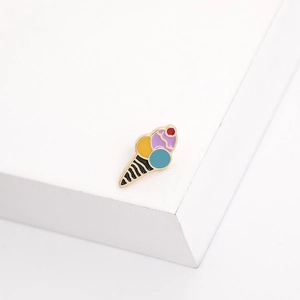 Close-up of colorful enamel ice cream cone brooch with red cherry on metal base