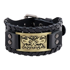 Detail of black braided leather wristband with vintage brass metal plate and buckle