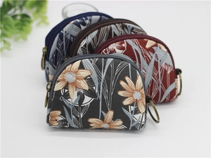 Semi-circular canvas coin purses with floral patterns, zipper closure and metal rings