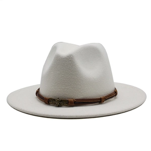 Close-up of brown braided band with bronze skull detail on a white fedora hat