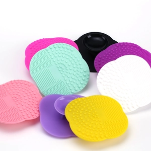 Detailed view of silicone brush cleansing pads with diverse textures and suction handles