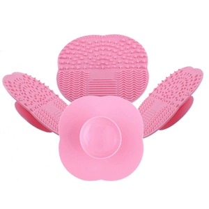Pink silicone makeup brush cleansing pads with suction cups and various cleaning textures