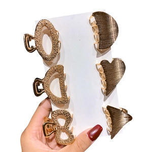 Set of 6 minimalist golden geometric metal hair claws in heart and round shapes