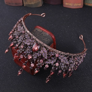 Macro detail of baroque bridal crown with deep purple crystals and bronze leaf texture