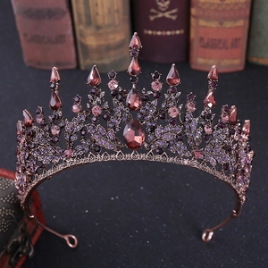 Detailed close-up of Baroque bridal crown with red gems and bronze leaf patterns