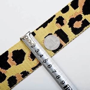 Detailed view showing the leopard print bag strap width at 3.8cm with measuring tape