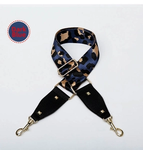 Detail of adjustable deep blue leopard print bag strap with golden rivets and hooks
