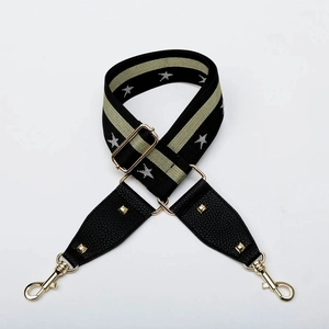 Detail of adjustable star-pattern strap with golden hardware and leather connector