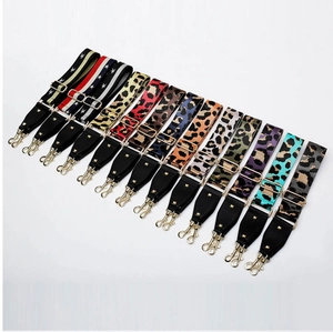Detailed view of multiple leopard print and star patterned adjustable bag straps with gold hardware