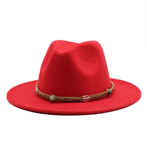 Detail of dark red wool fedora hat with woven band and vintage metal buckle ornament