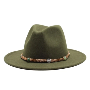 Detail of dark green wool fedora with a hand-woven brown band and turquoise bead accents