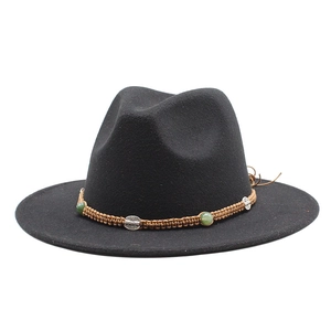 Detail of wool fedora hat with brown braided band, green beads and silver ornaments