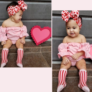 Infant girl set featuring pink off-shoulder romper with red heart bow headband and socks