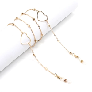 Golden minimalist eyewear chain with heart charms and silicone loops on white display