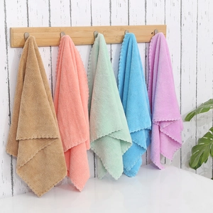 Five-pack thickening coral fleece face towels in multiple colors hanging on a wooden rack
