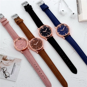 Close-up of four minimalist quartz watches with matte leather straps in assorted colors