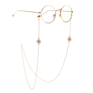 Golden metal eyewear chain with white daisy charms and non-slip rubber loops