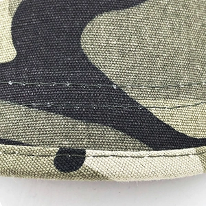 Detailed close-up of camouflage cotton fabric with durable double-stitched reinforced seams