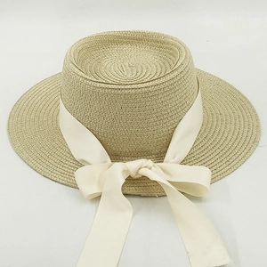 Women's outdoor straw boater hat with cream ribbon bow for sun protection in summer