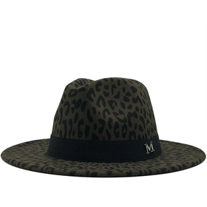 Detail of leopard print fedora hat featuring black ribbon and silver M metal charm