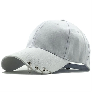 Minimalist white cotton baseball cap with three silver metal rings on the brim