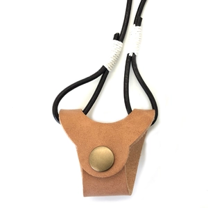Detail view of handmade faux leather eyewear lanyard with brass button and braided cords