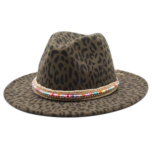 Detail of leopard print wool fedora featuring bohemian beaded band and braided rope trim