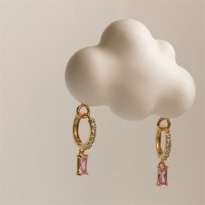 Golden hoop earrings featuring pink rectangular crystal charms and white rhinestones