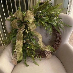 Pastoral style artificial green plant wreath with poppy berries on grapevine base
