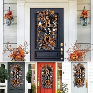 Halloween wreath with BOO letter design on front door with orange and black ribbons